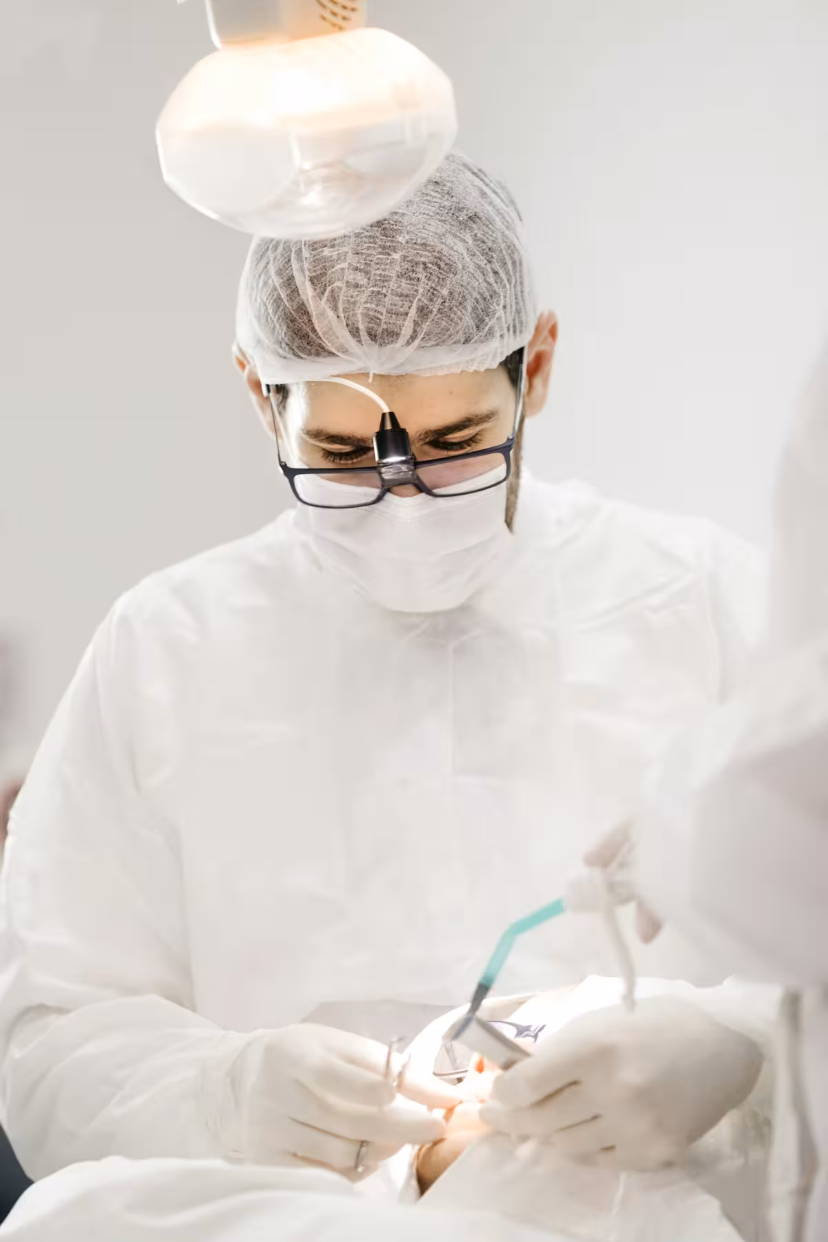 Close-up of a dental mirror and explorer resting on a paper tray cover.