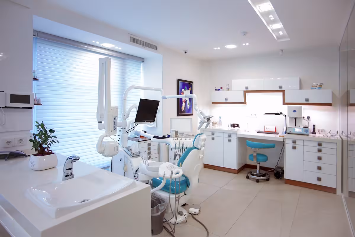 Dental student reviewing restorative case notes in a bright study space.